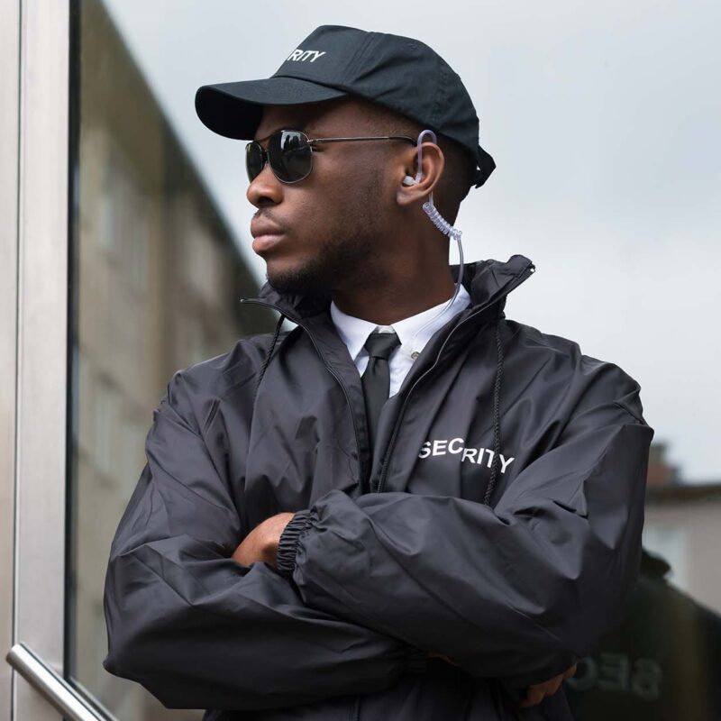 Portrait Of Young African Male Security Guard Standing Arms Crossed